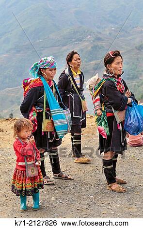 Stock Photograph - Black Hmong girls in ethnic dress in Lao Chai Village near Sapa, Vietnam, Asia.. Fotosearch