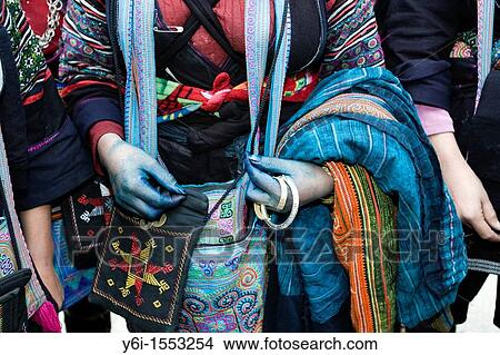 Picture - Black Hmong hilltribe woman with blue hands from dyed cloth Sapa Vietnam. Fotosearch