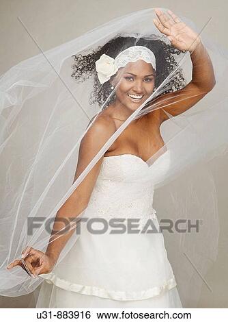 Black Latin Bride in her 20s discovers herself from under her veil View Large Photo Image Stock Photograph - Black Latin Bride in her 20s discovers herself from under her veil. Fotosearch
