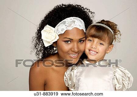 Black Latin Bride in her 20s poses with blond little girl View Large Photo Image Stock Photo - Black Latin Bride in her 20s poses with blond little girl. Fotosearch