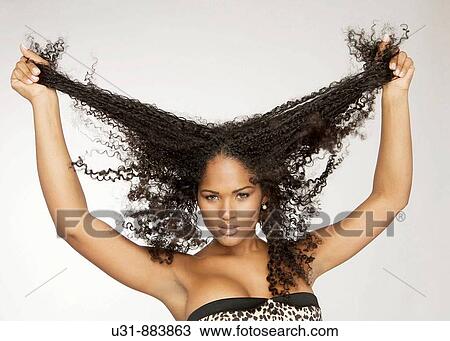 Black Latin girl pulls her sexy wavy hair View Large Photo Image Stock Image - Black Latin girl pulls her sexy wavy hair. Fotosearch