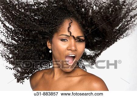 Stock Photo - Black Latin girl with sexy wavy hair. Fotosearch