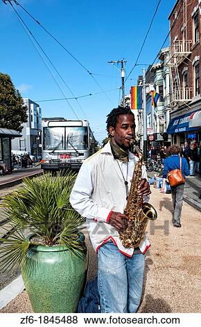 Black man playing sax in Gay Pride Weekend Pink Celebration in the gay Castro District of San Francisco California View Large Photo Image Stock Photo - Black man playing sax in Gay Pride Weekend Pink Celebration in the gay Castro District of San Francisco California. Fotosearch