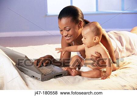 Black mother and child at computer View Large Photo Image Stock Photo - Black mother and child at computer. Fotosearch