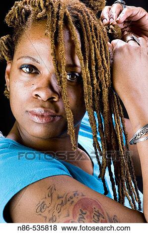 Black woman braiding her hair View Large Photo Image Stock Photo - Black woman braiding her hair. Fotosearch