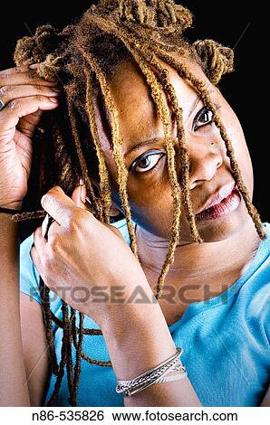Black woman braiding her hair View Large Photo Image Stock Photograph - Black woman braiding her hair. Fotosearch