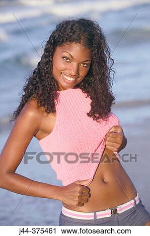 Black young woman at the beach smiling View Large Photo Image Stock Image - Black young woman at the beach smiling. Fotosearch