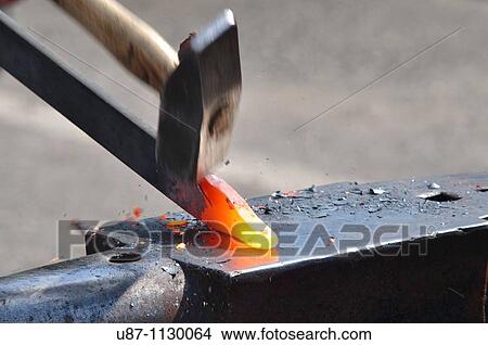 Blacksmith forging a red hot piece of iron View Large Photo Image Picture - Blacksmith forging a red hot piece of iron. Fotosearch