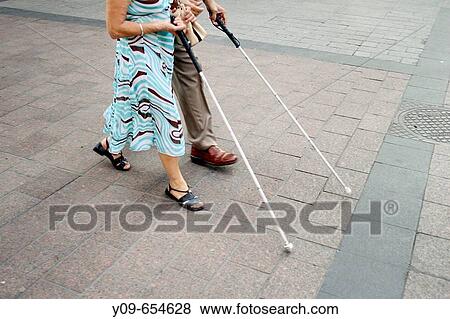 Blind people walking in the street View Large Photo Image Stock Photo - Blind people walking in the street. Fotosearch