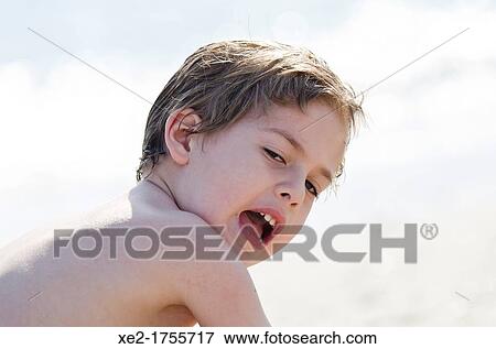 Stock Photo - Blond boy at the beach, Crete, Greece. Fotosearch