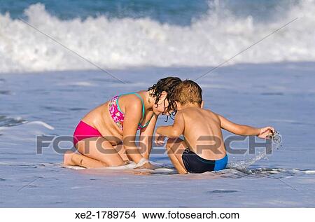 Blond child and girl at seaside, Crete, Greece View Large Photo Image Picture - Blond child and girl at seaside, Crete, Greece. Fotosearch