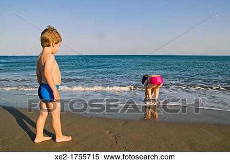 Stock Photography - Blond child and girl at seaside, Crete, Greece. Fotosearch