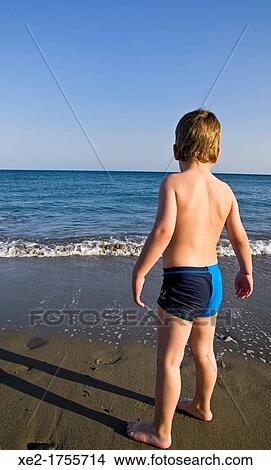 Blond child watching the waves, Crete, Greece View Large Photo Image Picture - Blond child watching the waves, Crete, Greece. Fotosearch