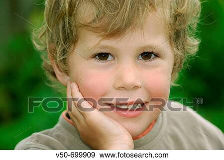 Blond, good looking child posing in a farm in Cambidge, New Zealand View Large Photo Image Stock Photo - Blond, good looking child posing in a farm in Cambidge, New Zealand. Fotosearch