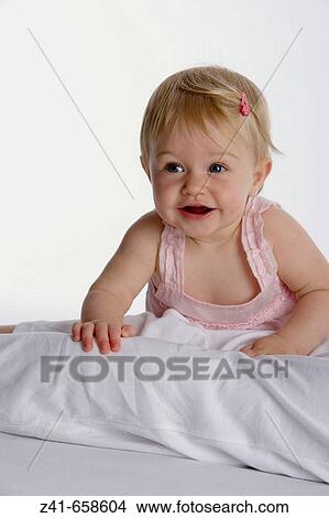 Blond little girl climbing on her mothers legs View Large Photo Image Picture - Blond little girl climbing on her mothers legs. Fotosearch