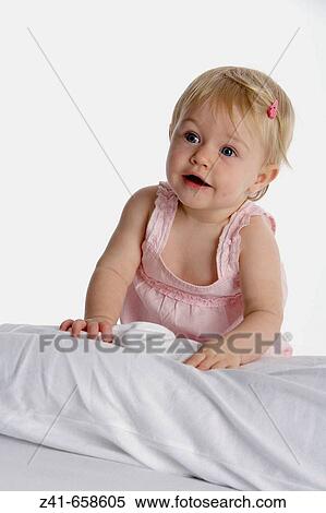 Blond little girl climbing on her mothers legs View Large Photo Image Stock Photography - Blond little girl climbing on her mothers legs. Fotosearch