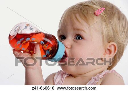 Blond little girl drinking from a bottle of lemonade View Large Photo Image Stock Photo - Blond little girl drinking from a bottle of lemonade. Fotosearch