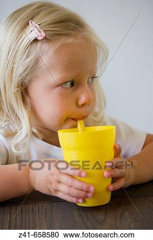 Blond little girl with a yellow cup View Large Photo Image Stock Image - Blond little girl with a yellow cup. Fotosearch
