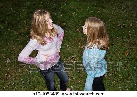 Blond preteen sisters in their backyard View Large Photo Image Stock Photo - Blond preteen sisters in their backyard. Fotosearch