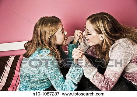 Blond preteen sisters together, one wearing glasses View Large Photo Image Stock Photo - Blond preteen sisters together, one wearing glasses. Fotosearch
