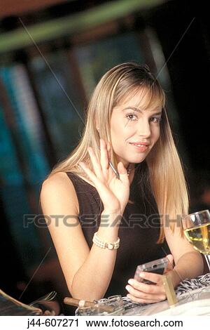 Blond woman sitting in a bar with electronic organizer View Large Photo Image Stock Image - Blond woman sitting in a bar with electronic organizer. Fotosearch