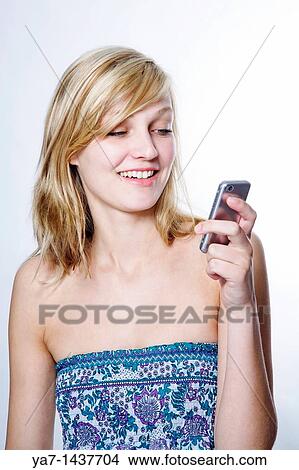 Blond Woman Texting on Mobile Phone View Large Photo Image Picture - Blond Woman Texting on Mobile Phone. Fotosearch