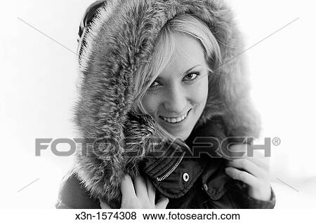 Stock Photo - Blond woman wearing parka. Fotosearch