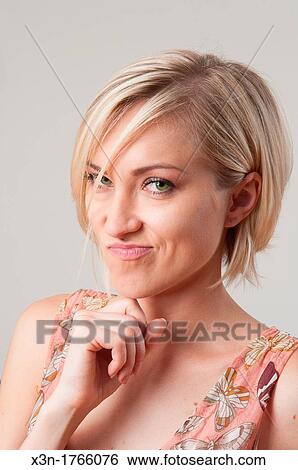 Blond woman with facial expression View Large Photo Image Stock Photograph - Blond woman with facial expression. Fotosearch