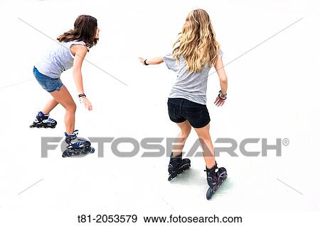 Blonde and brunette girls learning to skate View Large Photo Image Stock Photo - Blonde and brunette girls learning to skate. Fotosearch