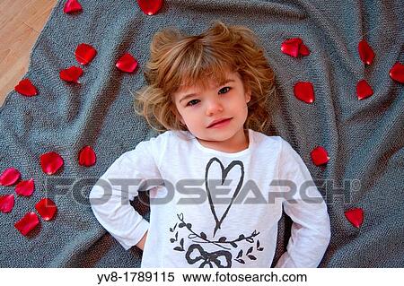 Blonde baby girl with rose petals View Large Photo Image Stock Photography - Blonde baby girl with rose petals. Fotosearch