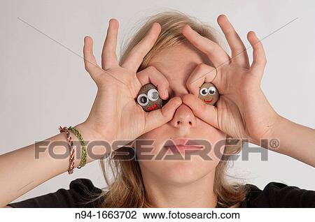 Blonde girl holding her hands in the shape of a pair of binoculars in front of her eyes. View Large Photo Image Stock Image - Blonde girl holding her hands in the shape of a pair of binoculars in front of her eyes.. Fotosearch