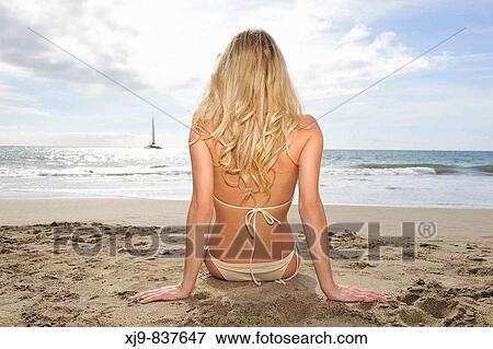 Blonde girl sitting on the beach look the horizon. View Large Photo Image Stock Photo - Blonde girl sitting on the beach look the horizon.. Fotosearch