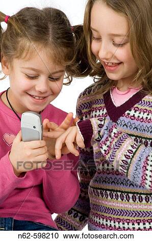 Blonde girls playing with their cell phone View Large Photo Image Stock Image - Blonde girls playing with their cell phone. Fotosearch