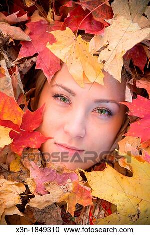 Blonde haired woman outdoors in leaf pile View Large Photo Image Stock Image - Blonde haired woman outdoors in leaf pile. Fotosearch