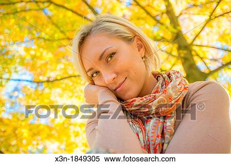 Blonde haired woman outdoors View Large Photo Image Stock Photography - Blonde haired woman outdoors. Fotosearch