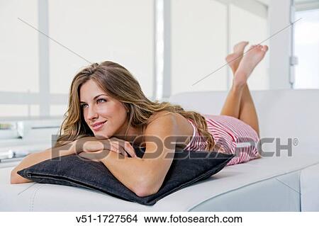 Blonde happy woman lying down on the couch View Large Photo Image Picture - Blonde happy woman lying down on the couch. Fotosearch