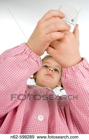 Stock Photo - Blonde schoolgirl with cell phone. Fotosearch