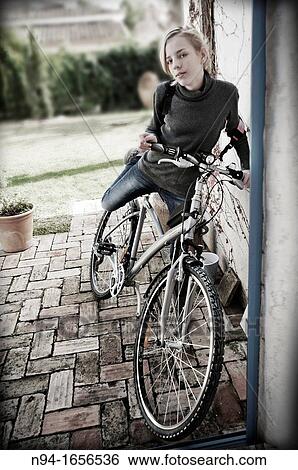 Stock Photograph - Blonde teen girl on bike. Fotosearch