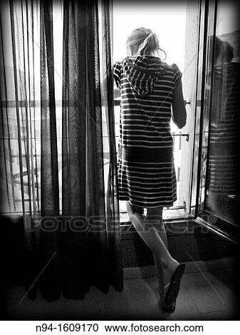 Blonde teen girl standing looking out a window. View Large Photo Image Stock Image - Blonde teen girl standing looking out a window.. Fotosearch