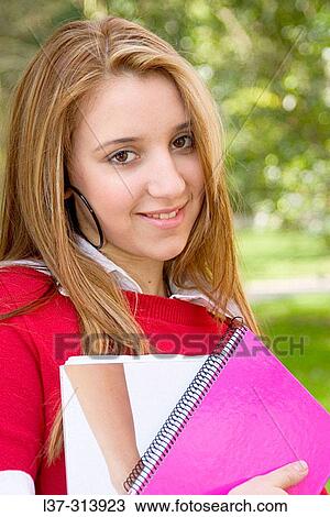 Blonde teenage girl with books in the park View Large Photo Image Stock Image - Blonde teenage girl with books in the park. Fotosearch