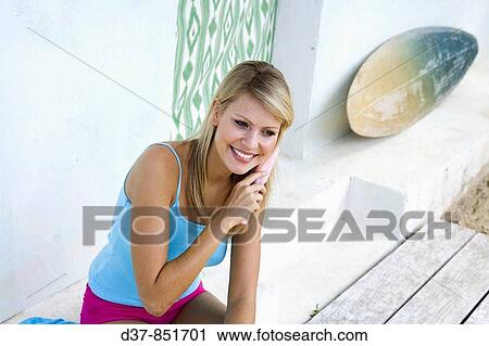 Blonde woman brushing her hair View Large Photo Image Stock Image - Blonde woman brushing her hair. Fotosearch
