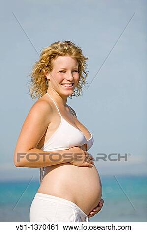 Blonde woman enjoying her pregnancy at the beach View Large Photo Image Stock Image - Blonde woman enjoying her pregnancy at the beach. Fotosearch
