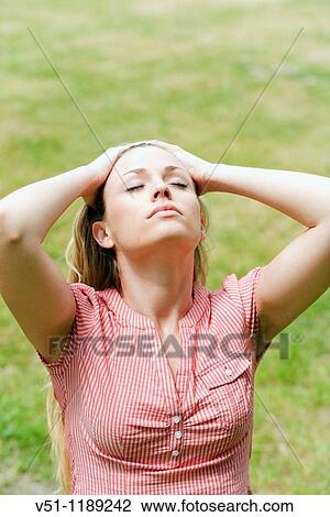 Blonde woman enjoying the sun in the park View Large Photo Image Stock Image - Blonde woman enjoying the sun in the park. Fotosearch