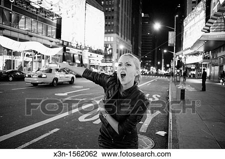 Blonde woman hailing taxi, Times Square New York at night View Large Photo Image Stock Image - Blonde woman hailing taxi, Times Square New York at night. Fotosearch