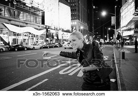 Blonde woman hailing taxi, Times Square New York at night View Large Photo Image Stock Image - Blonde woman hailing taxi, Times Square New York at night. Fotosearch