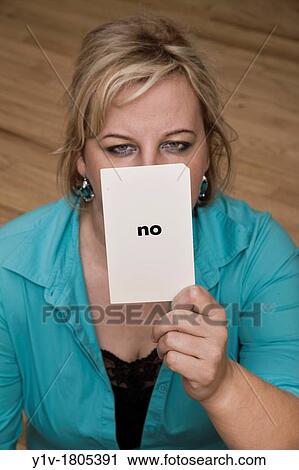 Blonde woman holding a card reading,? no? View Large Photo Image Stock Image - Blonde woman holding a card reading,? no?. Fotosearch