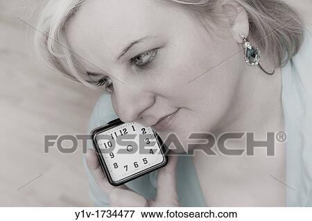 Blonde woman holding a clock that has no hands View Large Photo Image Stock Photo - Blonde woman holding a clock that has no hands. Fotosearch
