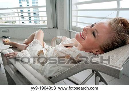Blonde Woman in Lounge Chair - South Florida, USA. View Large Photo Image Stock Image - Blonde Woman in Lounge Chair - South Florida, USA.. Fotosearch