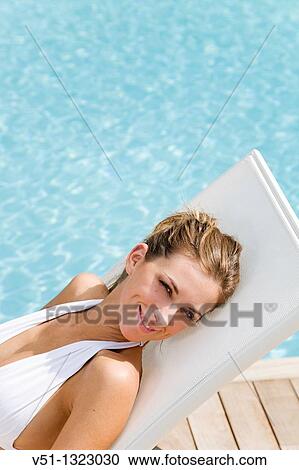 Blonde woman lying down in Hammock by the pool View Large Photo Image Stock Image - Blonde woman lying down in Hammock by the pool. Fotosearch