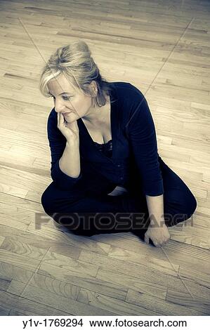 Blonde woman sitting on the floor View Large Photo Image Picture - Blonde woman sitting on the floor. Fotosearch